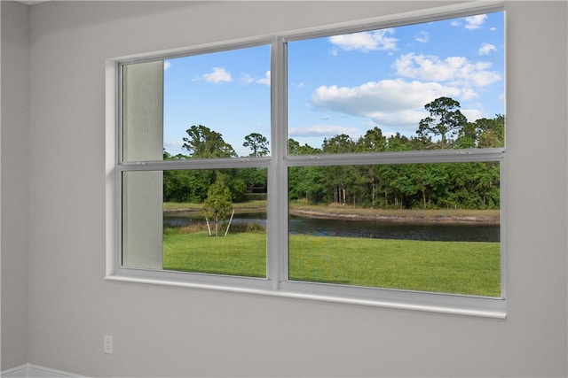 interior space with a water view and a healthy amount of sunlight