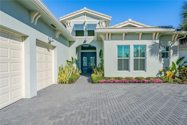 doorway to property featuring a garage and french doors