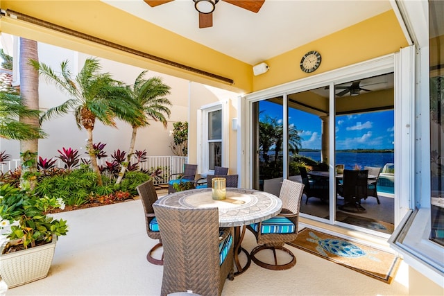 view of patio / terrace with a water view and ceiling fan