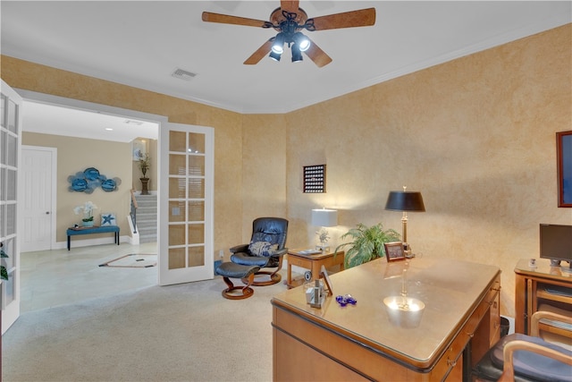 home office with ceiling fan, crown molding, light carpet, and french doors