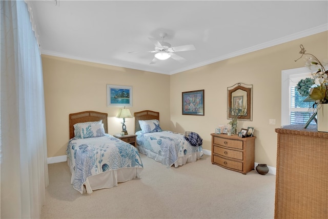 carpeted bedroom with ceiling fan and ornamental molding