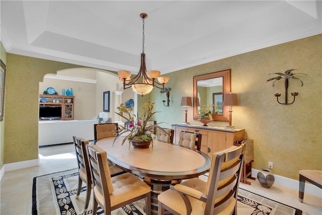 dining room with ornamental molding, light tile patterned floors, a raised ceiling, and an inviting chandelier