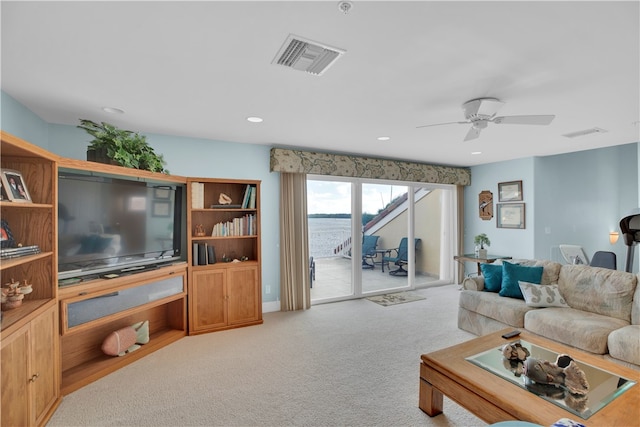 carpeted living room featuring ceiling fan