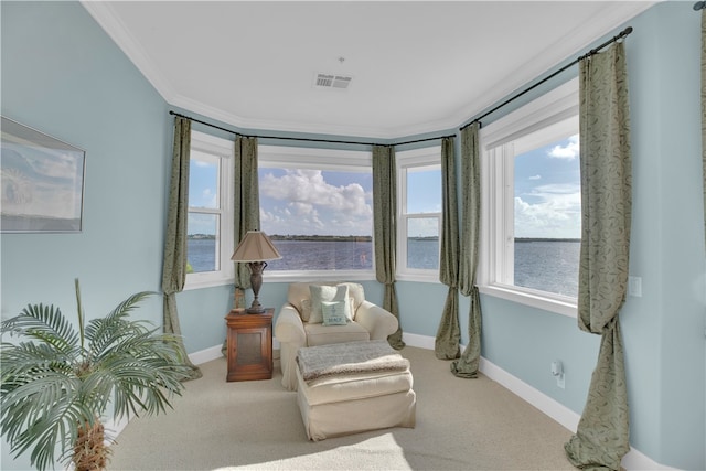 sitting room with a water view, carpet, and ornamental molding