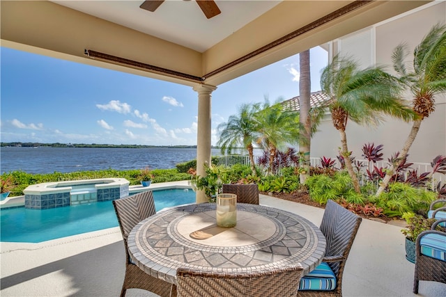 view of patio with central AC unit, a water view, and a swimming pool with hot tub