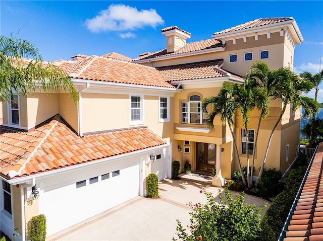 mediterranean / spanish house with a garage