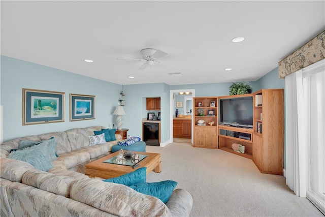 carpeted living room with ceiling fan