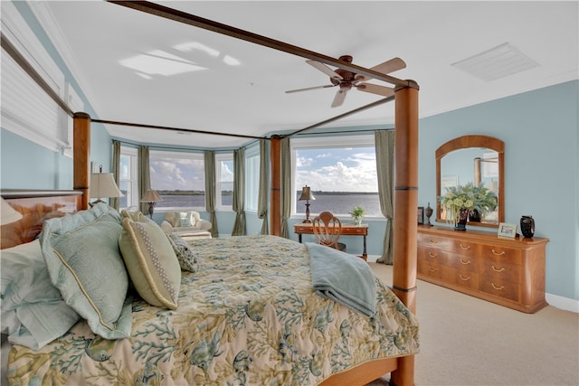 carpeted bedroom featuring ceiling fan and crown molding