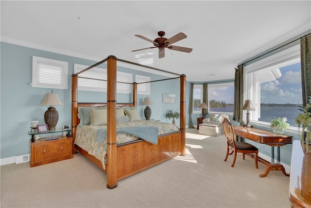 bedroom featuring light colored carpet, ceiling fan, a water view, and ornamental molding