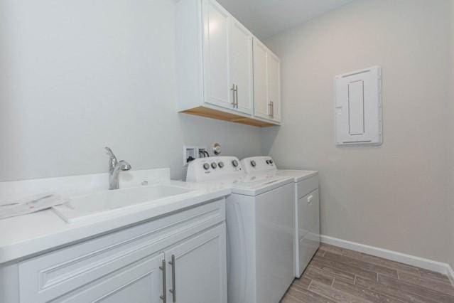 washroom with sink, cabinets, and separate washer and dryer