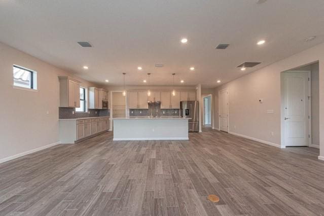 unfurnished living room featuring hardwood / wood-style flooring