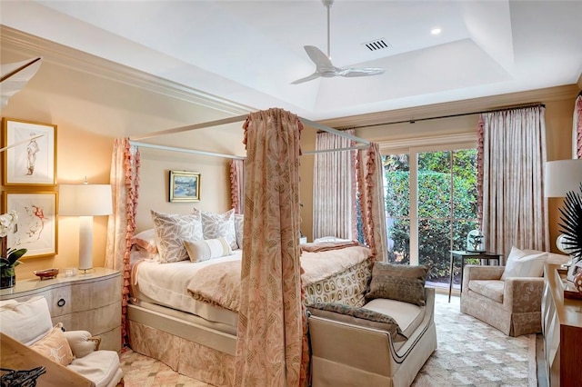 bedroom with crown molding, ceiling fan, and a tray ceiling