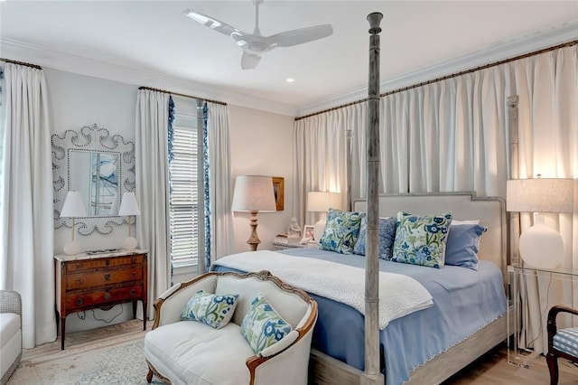 bedroom featuring crown molding, ceiling fan, and light wood-type flooring