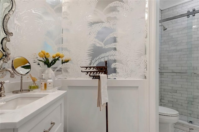 bathroom with an enclosed shower, vanity, and toilet