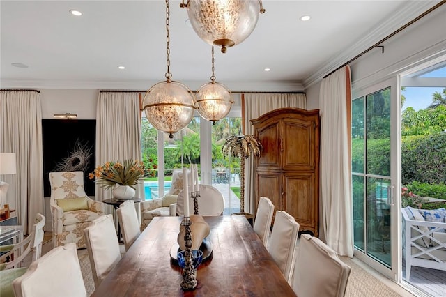 dining area featuring crown molding, plenty of natural light, and a chandelier