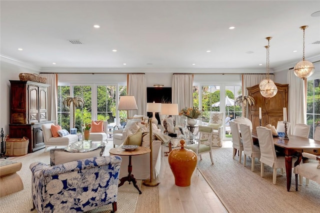 living room with light hardwood / wood-style flooring and ornamental molding