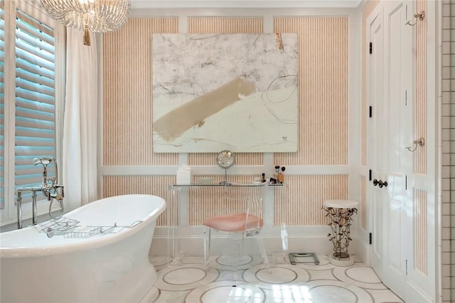 bathroom with an inviting chandelier and a bathing tub