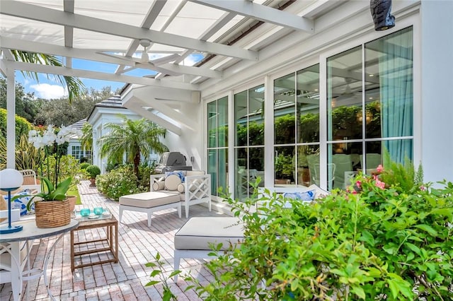 exterior space with area for grilling and a pergola