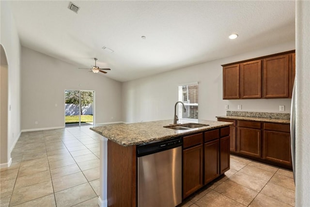8157 Westfield Cir, Vero Beach, FL 32966 - kitchen featuring lofted ceiling, a sink, stainless steel dishwasher, light stone countertops, and a center island with sink