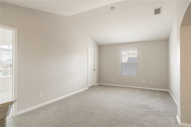 8157 Westfield Cir, Vero Beach, FL 32966 - unfurnished room featuring light colored carpet, visible vents, lofted ceiling, and baseboards