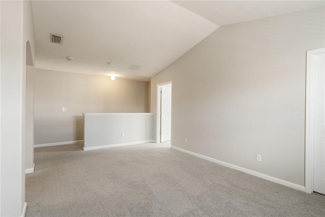 8157 Westfield Cir, Vero Beach, FL 32966 - spare room featuring lofted ceiling, arched walkways, carpet floors, visible vents, and baseboards