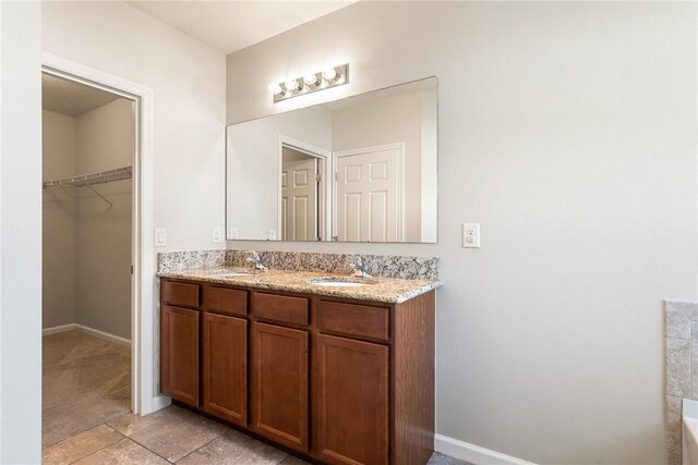 8157 Westfield Cir, Vero Beach, FL 32966 - bathroom with a sink, a spacious closet, baseboards, and double vanity