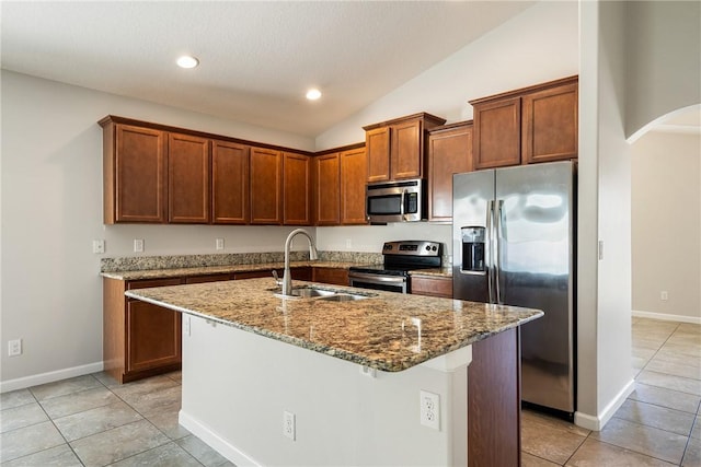 8157 Westfield Cir, Vero Beach, FL 32966 - kitchen featuring arched walkways, stone countertops, a sink, vaulted ceiling, and appliances with stainless steel finishes