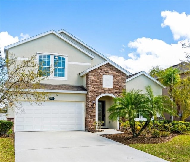 traditional-style house featuring stone siding, driveway, an attached garage, and stucco siding