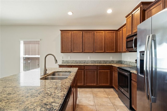 8157 Westfield Cir, Vero Beach, FL 32966 - kitchen featuring light stone counters, light tile patterned floors, stainless steel appliances, recessed lighting, and a sink