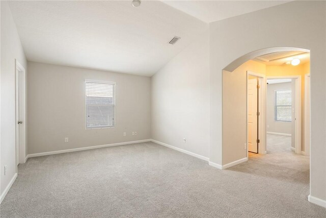 8157 Westfield Cir, Vero Beach, FL 32966 - unfurnished room featuring arched walkways, baseboards, visible vents, and light colored carpet