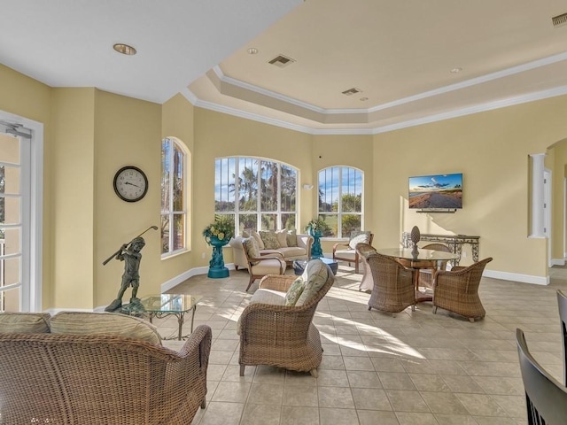 interior space with light tile patterned floors, baseboards, visible vents, and ornamental molding