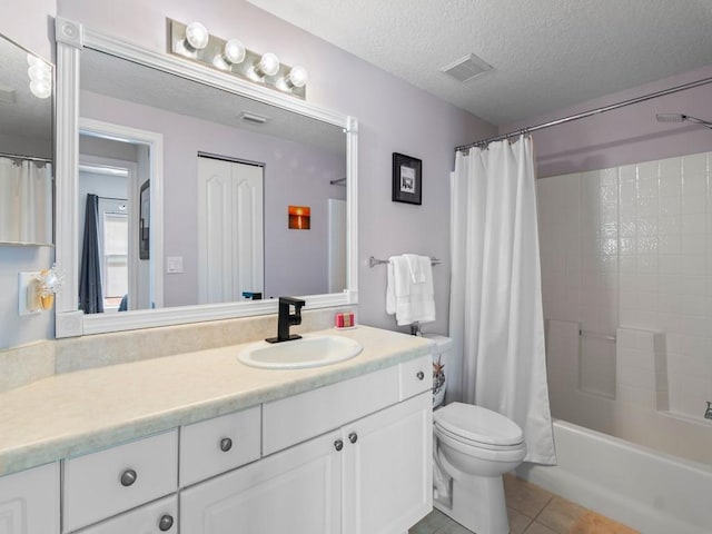 full bath featuring tile patterned floors, visible vents, toilet, a textured ceiling, and vanity