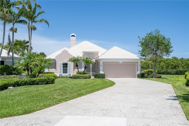 view of front facade featuring a front lawn and a garage