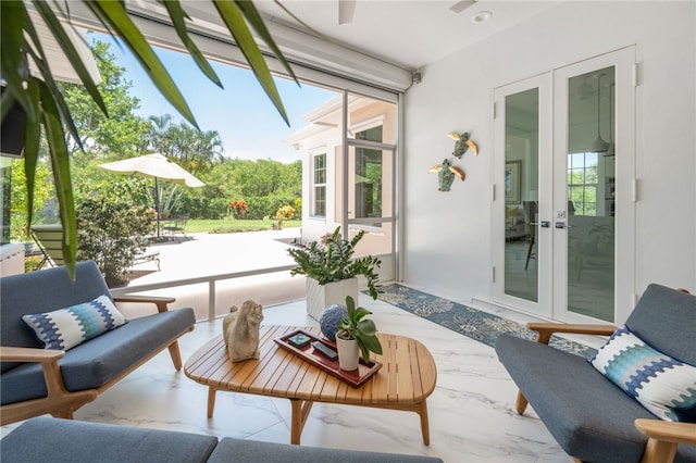 sunroom / solarium featuring french doors