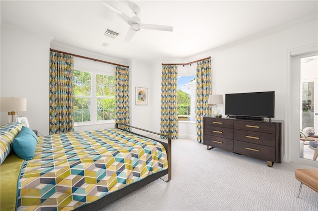 bedroom featuring ceiling fan, carpet floors, and ornamental molding