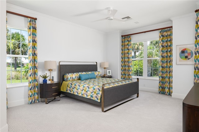 carpeted bedroom featuring multiple windows, ceiling fan, and crown molding