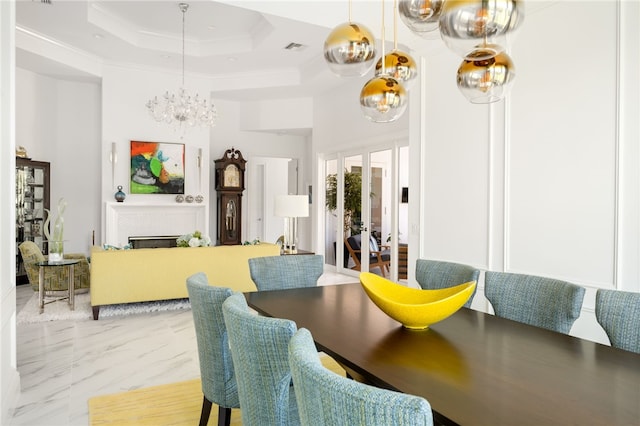 dining space featuring an inviting chandelier, a raised ceiling, and ornamental molding