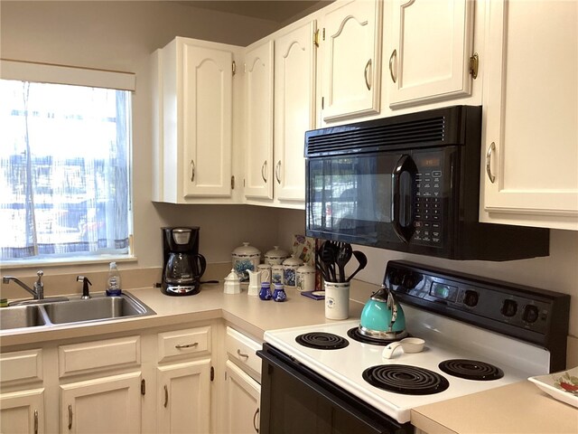 kitchen with white cabinetry, white electric stove, and sink