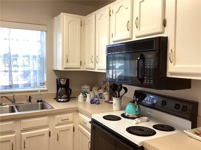 44 Vista Gardens Trail Trl Unit 101, Vero Beach, FL 32962 - kitchen featuring electric stove, black microwave, a sink, white cabinetry, and light countertops