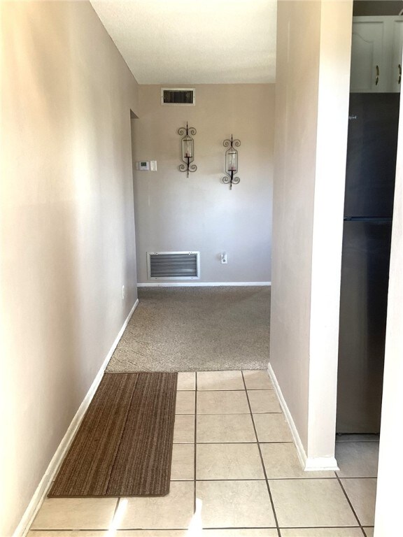 hall with light tile patterned flooring