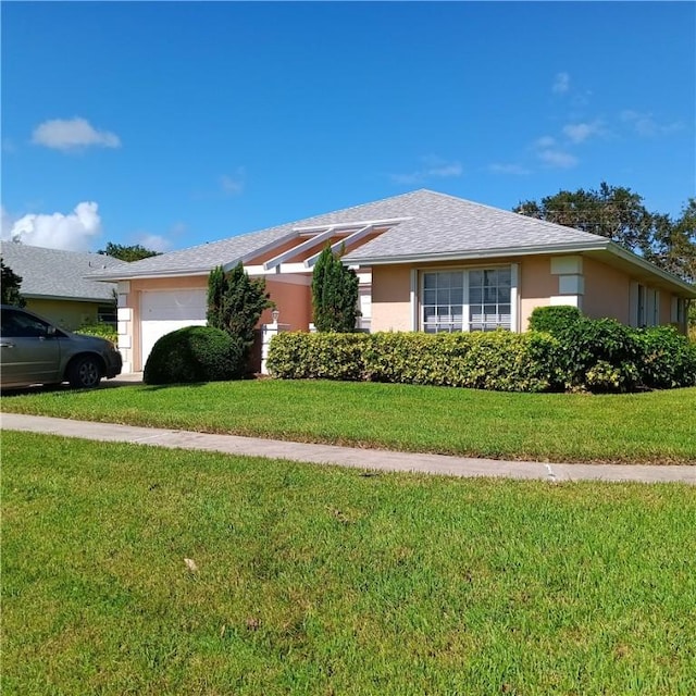 single story home with a garage and a front yard