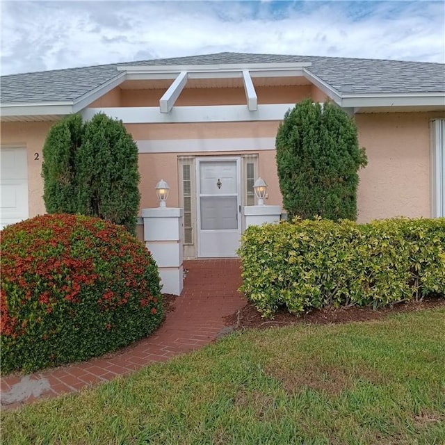 doorway to property featuring a lawn