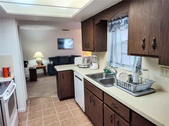 kitchen featuring dishwashing machine, a sink, light countertops, white electric range oven, and dark brown cabinets