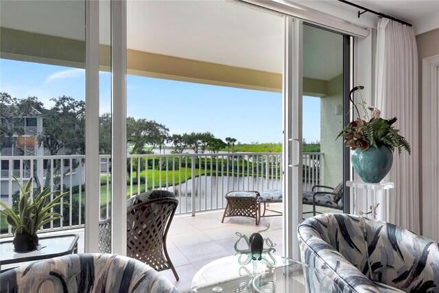 interior space with a wealth of natural light and a water view