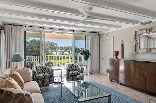 living room featuring a wealth of natural light, beamed ceiling, light tile patterned floors, and ceiling fan