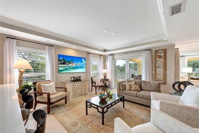 living room featuring light tile patterned floors and a raised ceiling