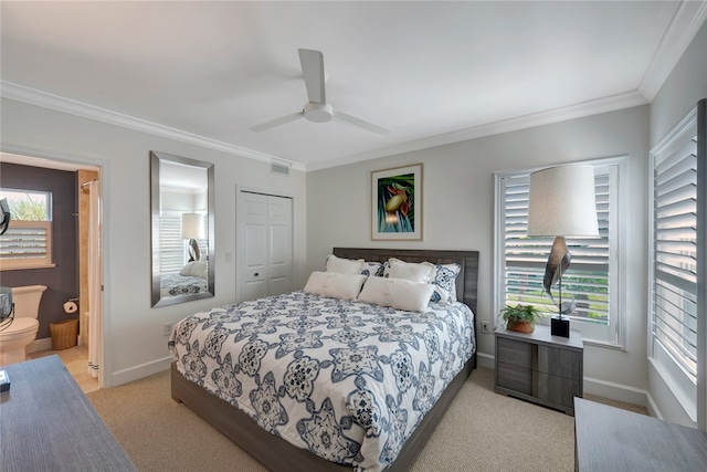 carpeted bedroom featuring ornamental molding, ceiling fan, and a closet