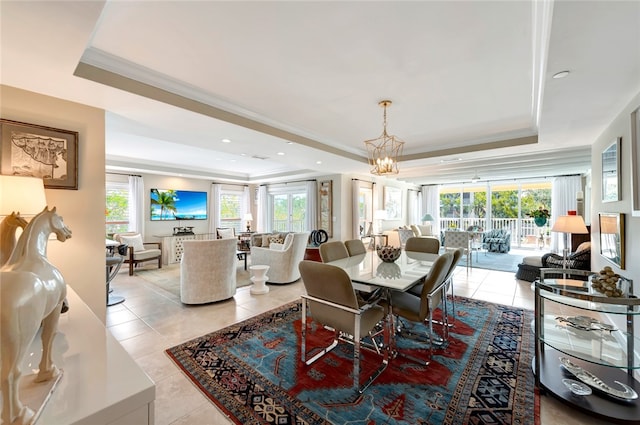 dining area with plenty of natural light, light tile patterned floors, and a tray ceiling