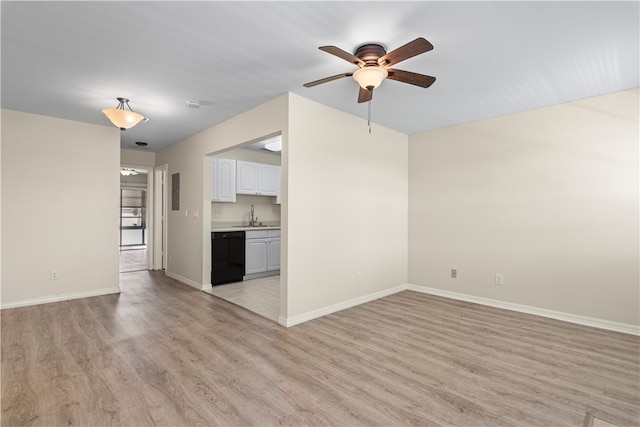 unfurnished living room featuring light hardwood / wood-style flooring, sink, and ceiling fan