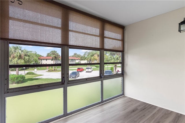 spare room featuring hardwood / wood-style floors and plenty of natural light